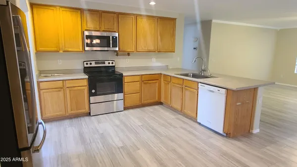 a kitchen with sink cabinets and wooden floor