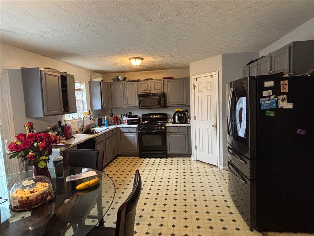 526 Canady Court Hampton, GA 30228 - Photo 6 of 10 a kitchen with granite countertop a refrigerator and a sink