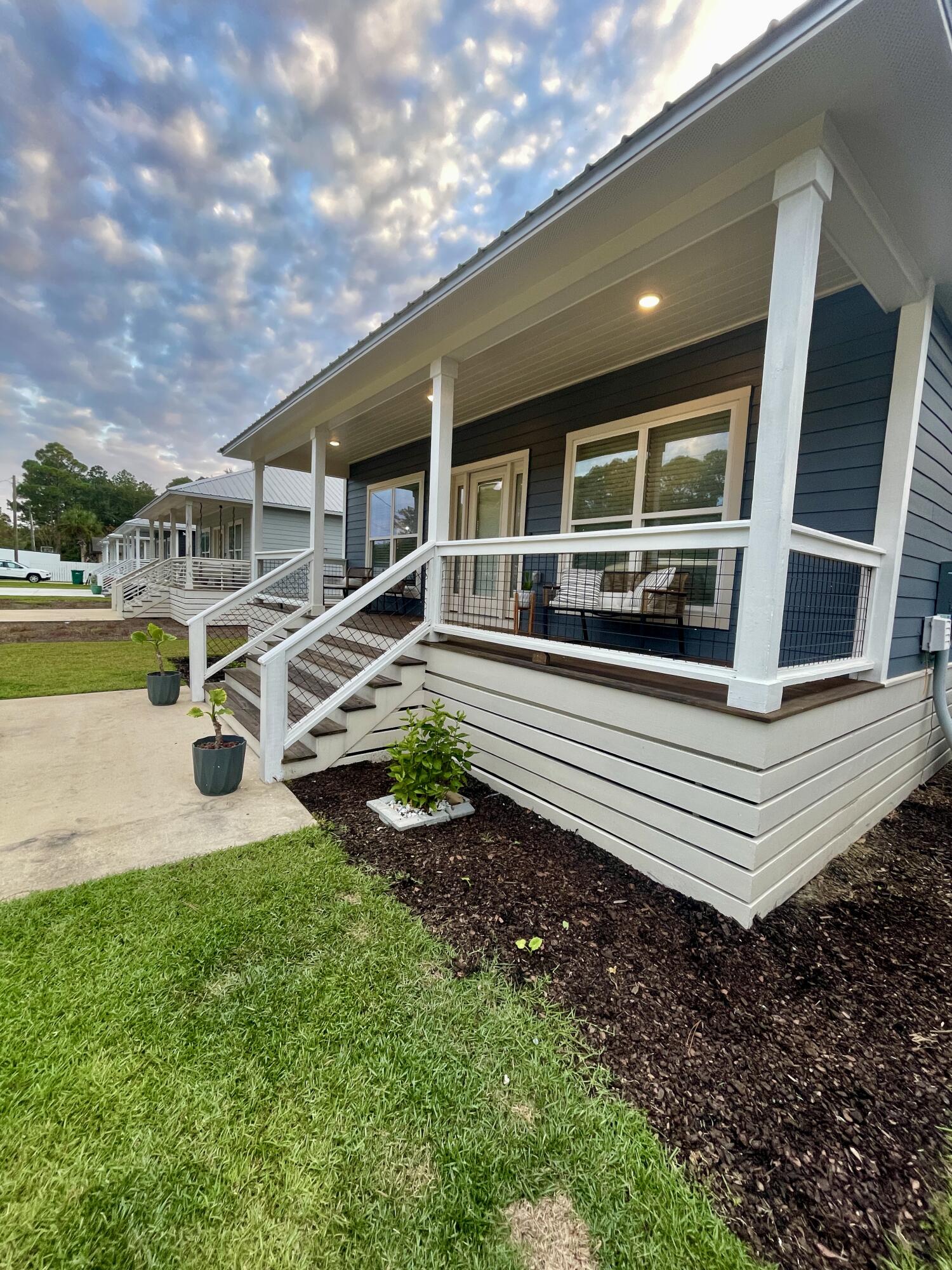 105 1st Street Santa Rosa Beach, FL 32459 - Photo 1 of 35 a front view of a house with garden and swimming pool