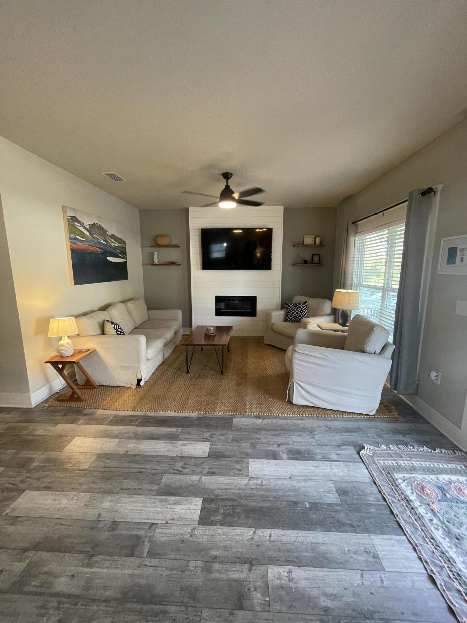 105 1st Street Santa Rosa Beach, FL 32459 - Photo 12 of 35 a living room with furniture and a flat screen tv