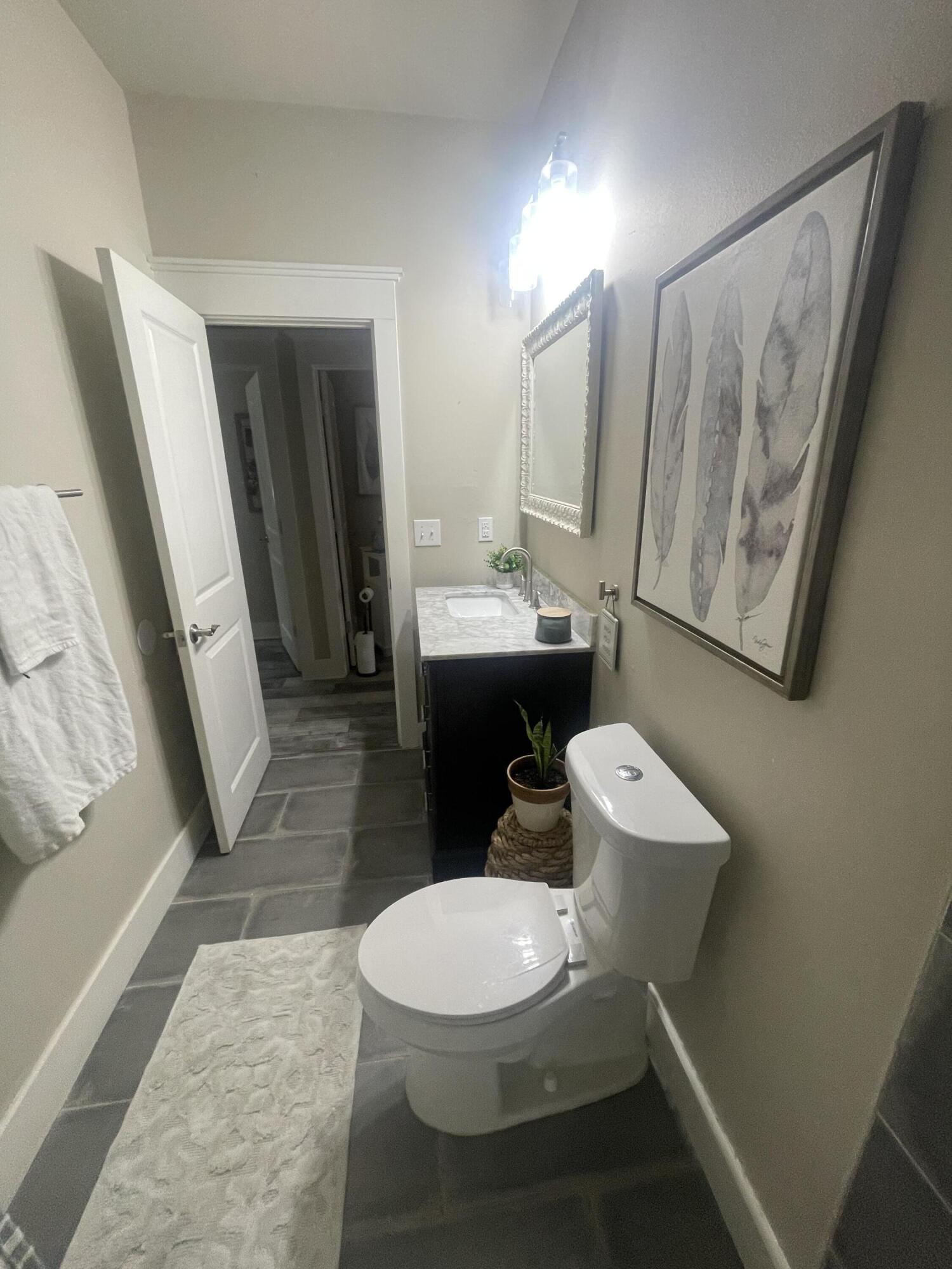 105 1st Street Santa Rosa Beach, FL 32459 - Photo 20 of 35 a white toilet sitting next to a bathroom sink