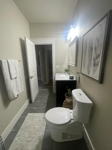 a white toilet sitting next to a bathroom sink