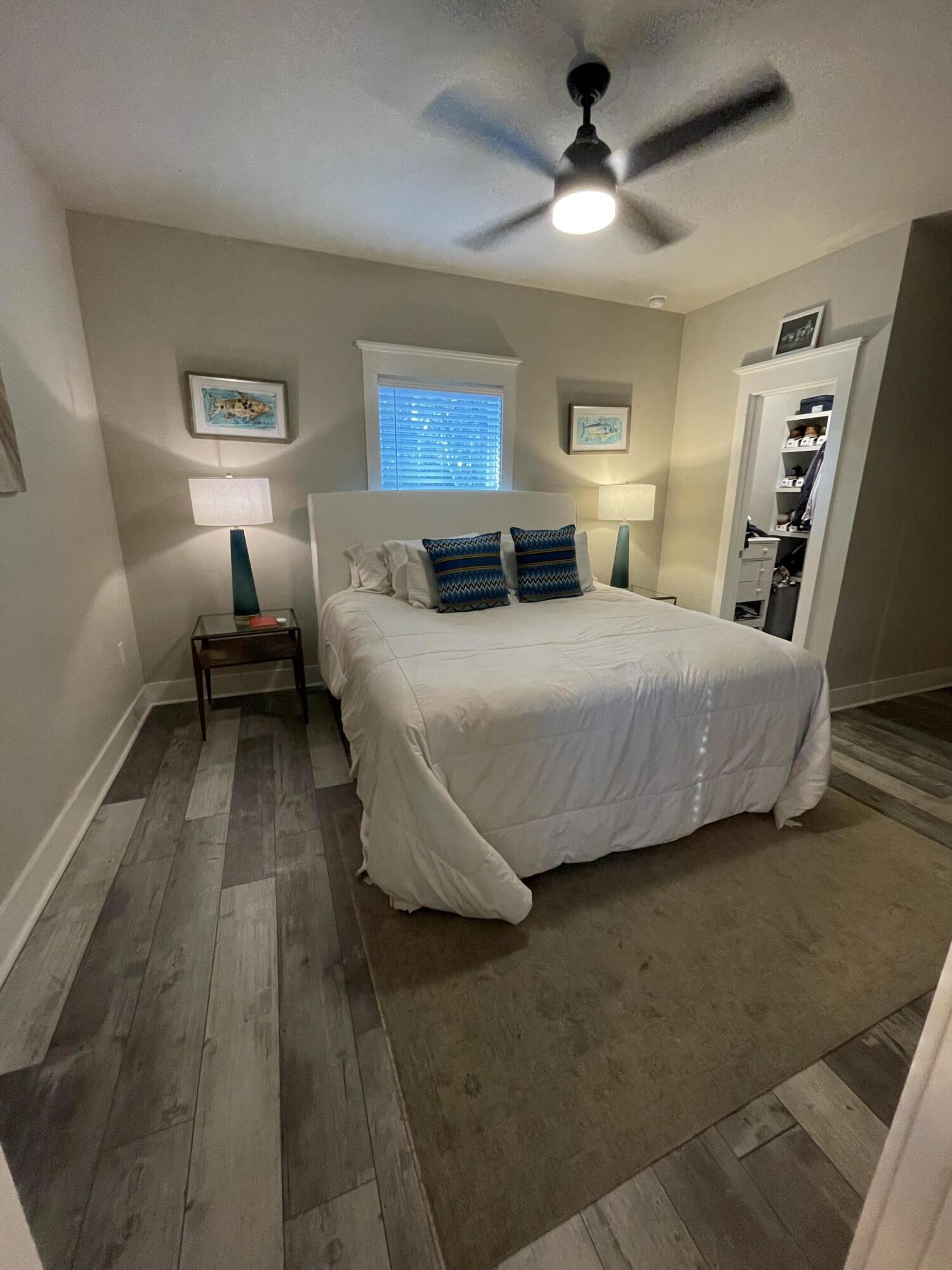 105 1st Street Santa Rosa Beach, FL 32459 - Photo 25 of 35 a bedroom with a bed and a chandelier