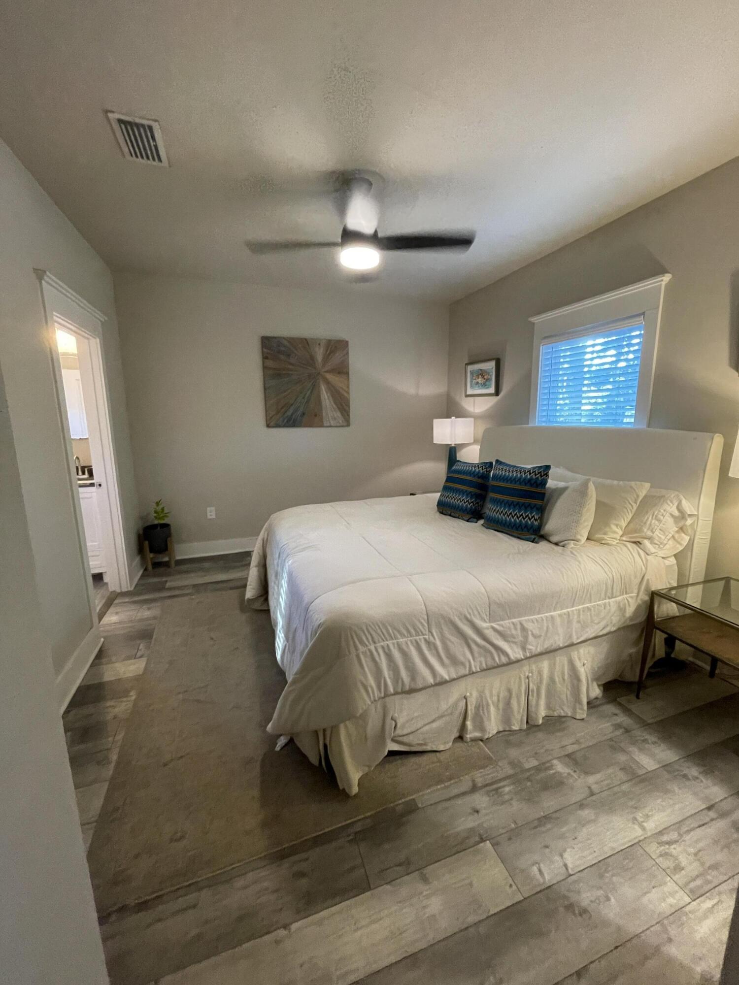105 1st Street Santa Rosa Beach, FL 32459 - Photo 26 of 35 a bedroom with a bed and a mirror