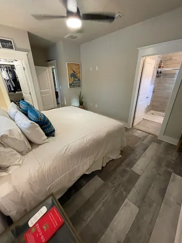 a bedroom with a bed and a mirror