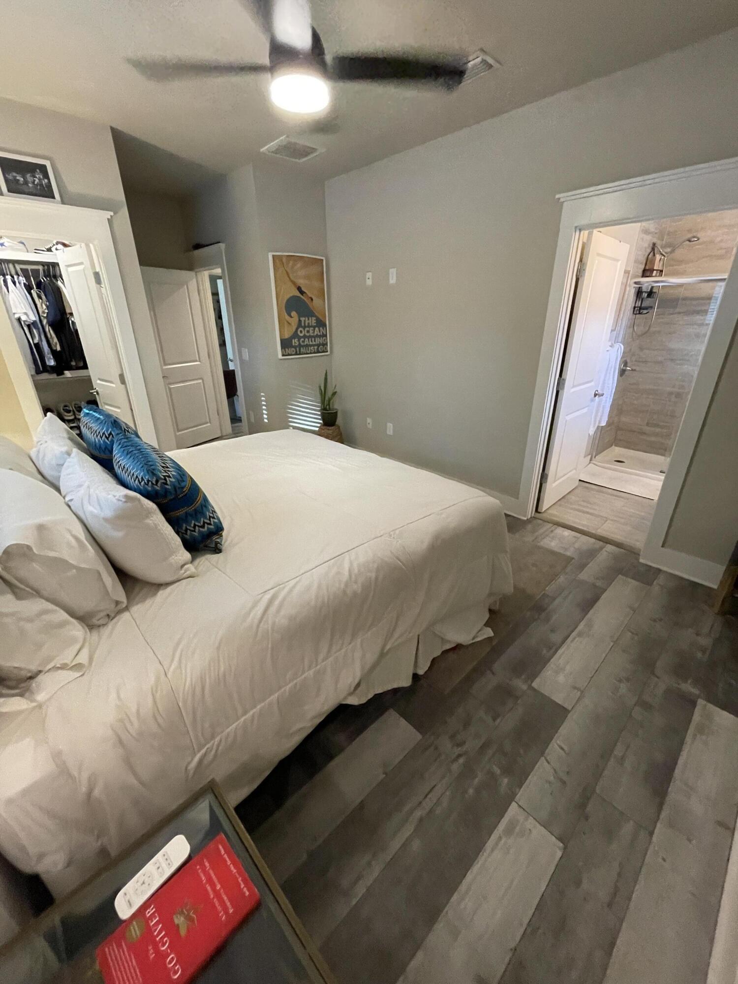 105 1st Street Santa Rosa Beach, FL 32459 - Photo 28 of 35 a bedroom with a bed and a mirror