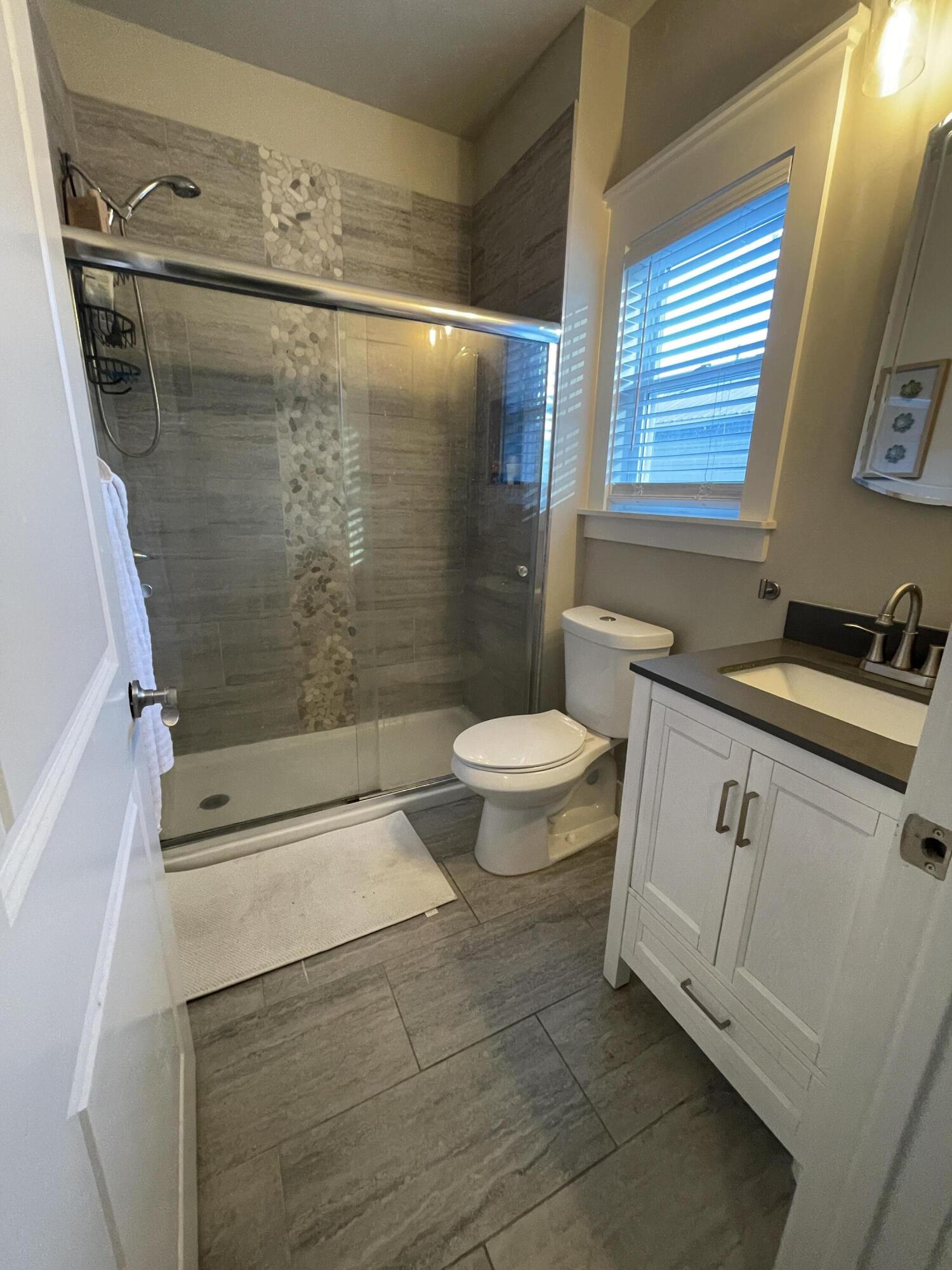 105 1st Street Santa Rosa Beach, FL 32459 - Photo 29 of 35 a bathroom with a granite countertop sink toilet and shower