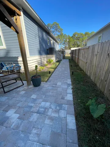 a view of a backyard with pathway