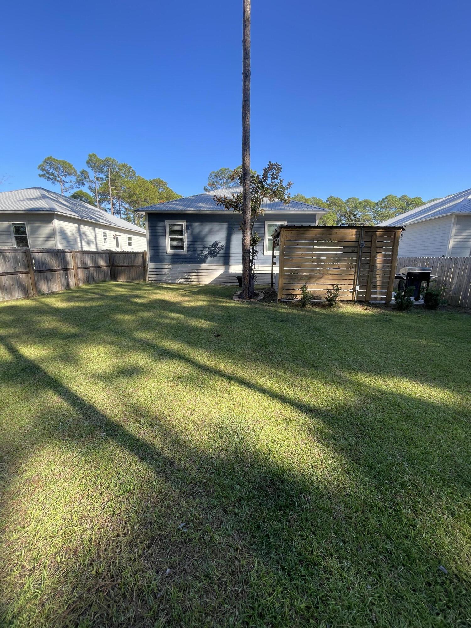 105 1st Street Santa Rosa Beach, FL 32459 - Photo 6 of 35 a front view of a house with a garden