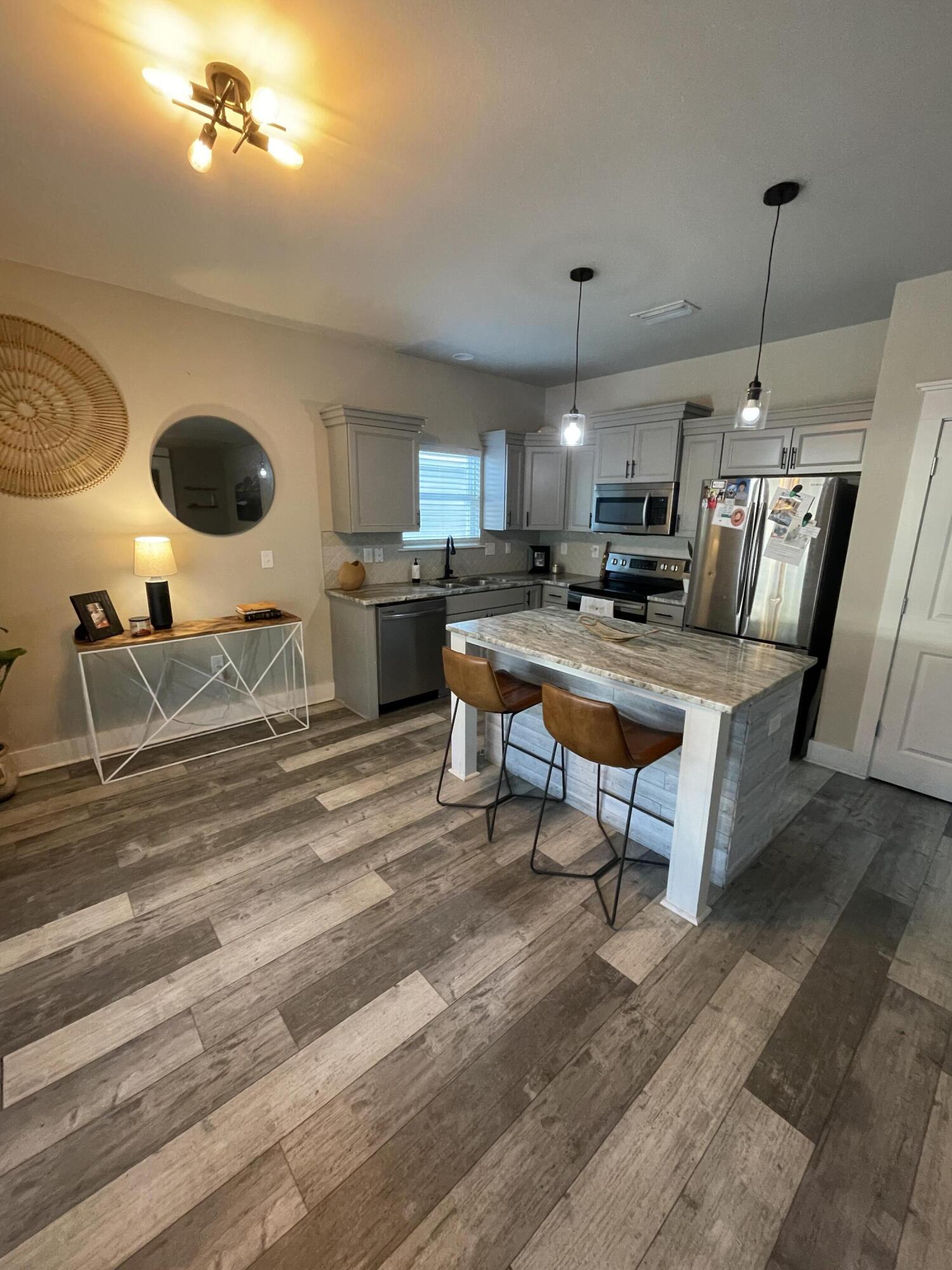 105 1st Street Santa Rosa Beach, FL 32459 - Photo 9 of 35 a living room with furniture a rug and white walls