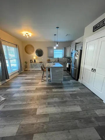a living room with furniture and a large mirror