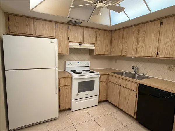 a kitchen with stainless steel appliances a refrigerator sink and cabinets