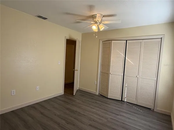 a view of an empty room with wooden floor