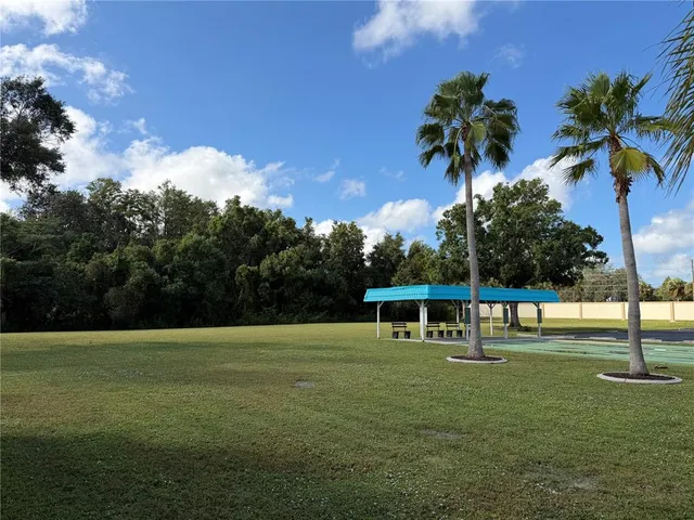 a view of a swimming pool with outdoor seating