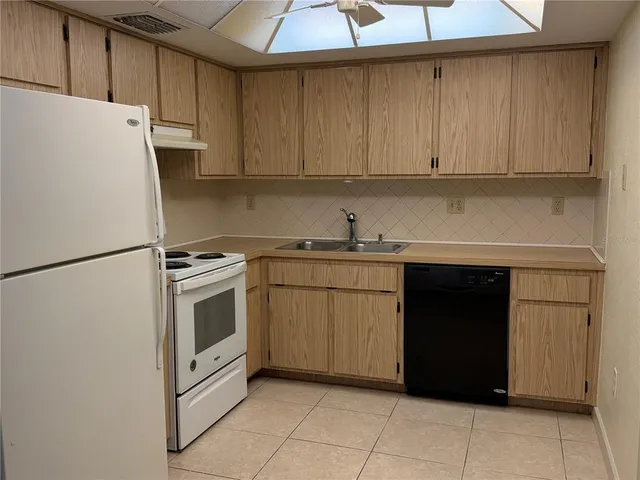 a kitchen with a cabinets and white appliances