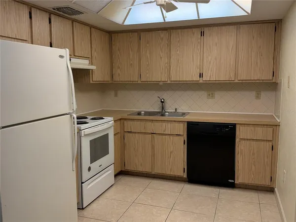 a kitchen with a cabinets and white appliances
