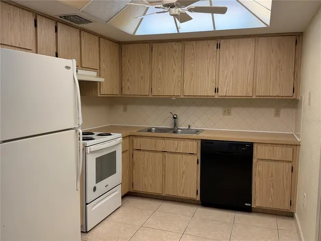 a kitchen with stainless steel appliances a refrigerator sink and cabinets