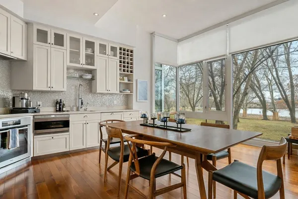 a kitchen with a table chairs stove and cabinets