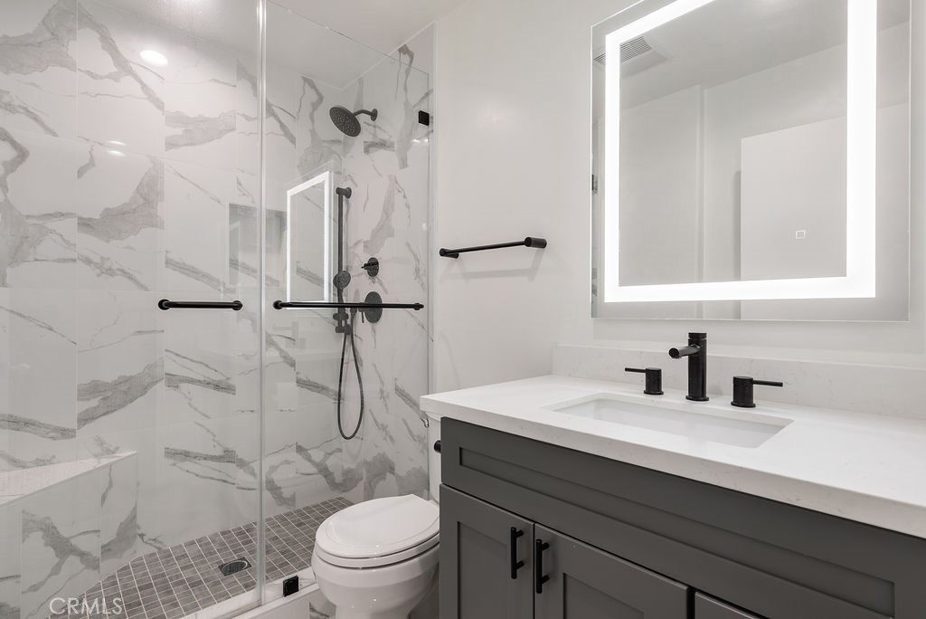 1434 South Point View Street Los Angeles, CA 90035 - Photo 12 of 16 a bathroom with a sink toilet vanity and shower