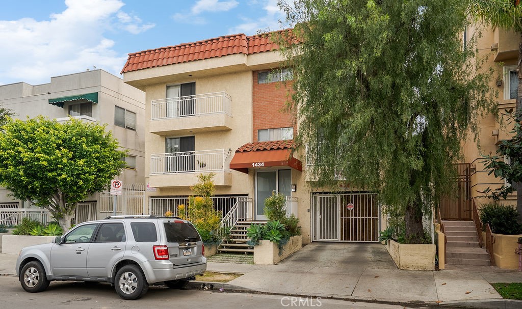 1434 South Point View Street Los Angeles, CA 90035 - Photo 15 of 16 a car parked in front of a house