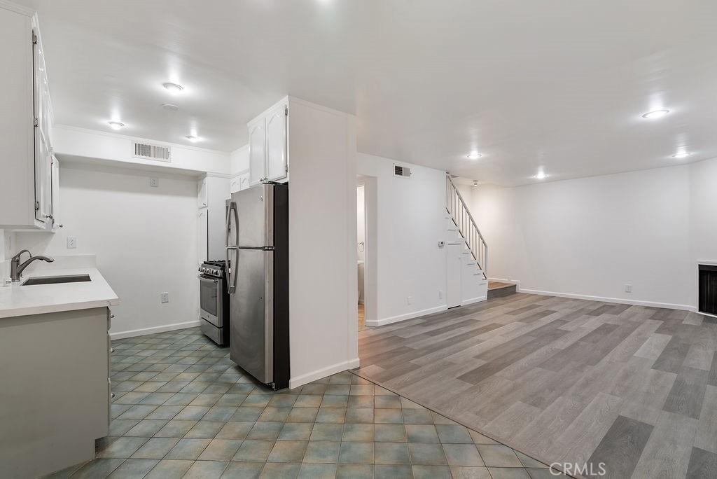 1434 South Point View Street Los Angeles, CA 90035 - Photo 3 of 16 a view of a kitchen with a refrigerator and a sink
