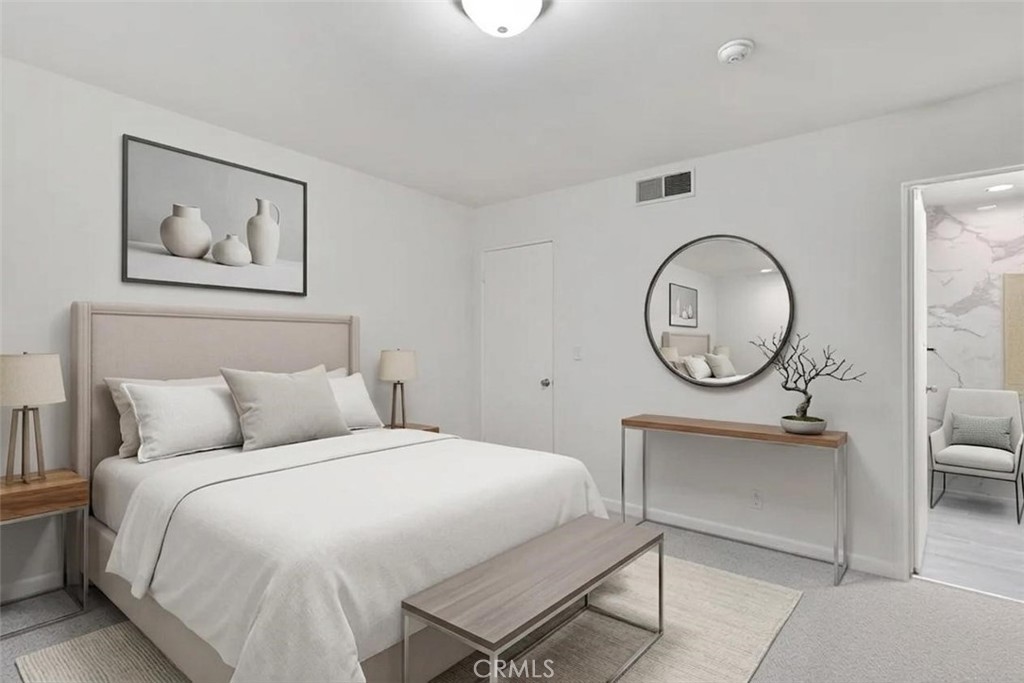 1434 South Point View Street Los Angeles, CA 90035 - Photo 4 of 11 a bedroom with a bed a mirror and a chandelier