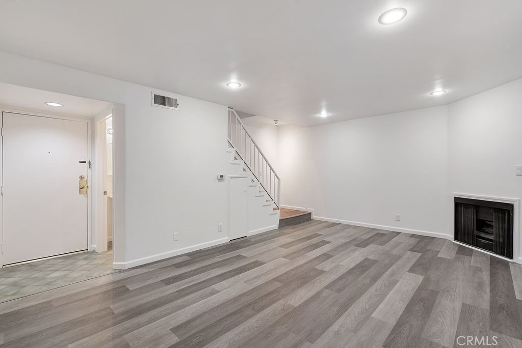 1434 South Point View Street Los Angeles, CA 90035 - Photo 4 of 16 wooden floor in an empty room with a fireplace