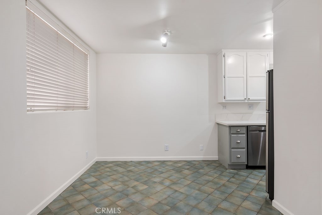 1434 South Point View Street Los Angeles, CA 90035 - Photo 5 of 16 a view of an empty room with kitchen cabinet and a window