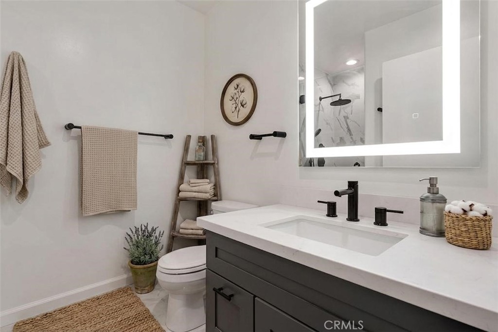 1434 South Point View Street Los Angeles, CA 90035 - Photo 7 of 11 a bathroom with a sink a toilet and a mirror