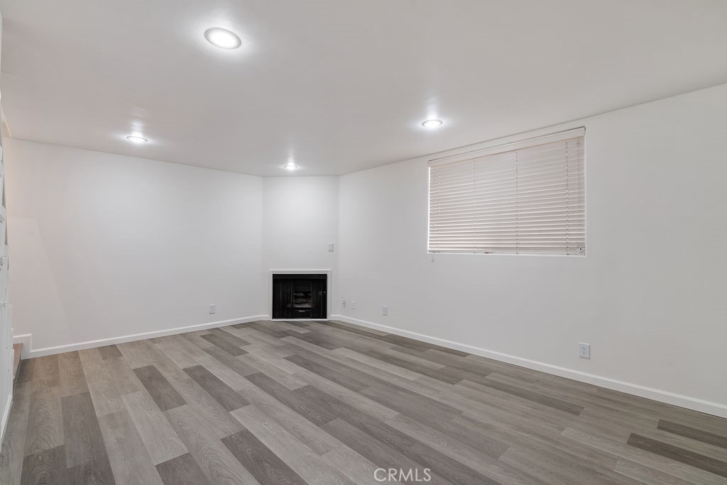 1434 South Point View Street Los Angeles, CA 90035 - Photo 8 of 16 an empty room with wooden floor and windows