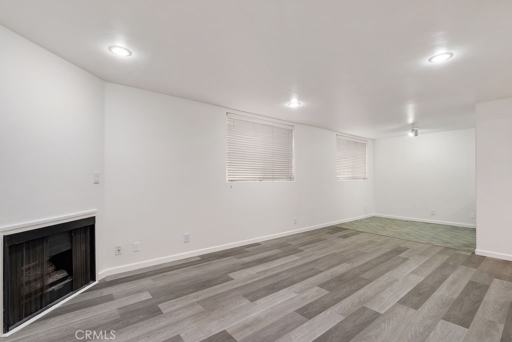 1434 South Point View Street Los Angeles, CA 90035 - Photo 9 of 16 a view of empty room with wooden floor and fireplace
