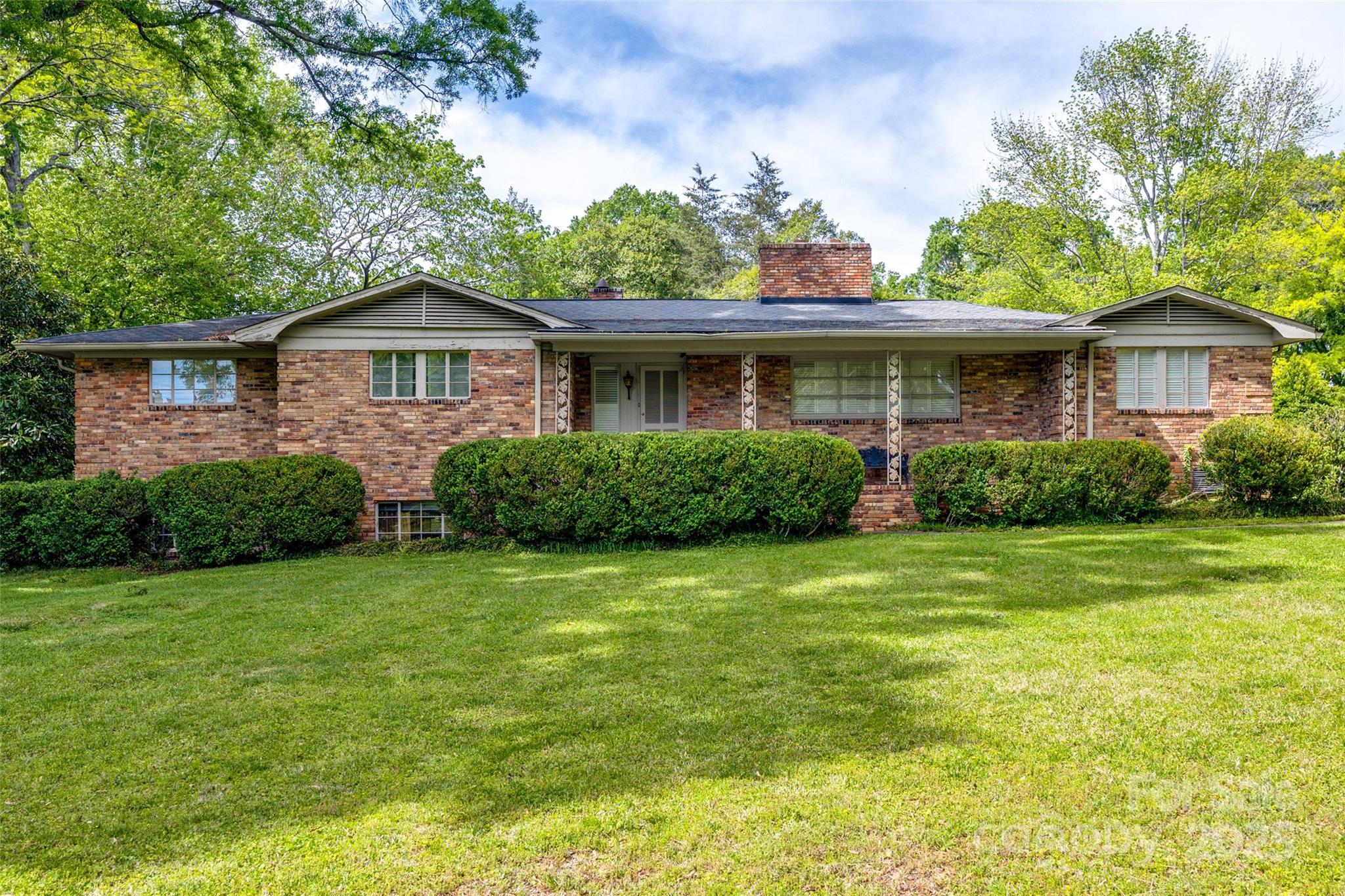 3330 Foxcroft Road Charlotte, NC 28211 - Photo 2 of 39 a front view of a house with a garden