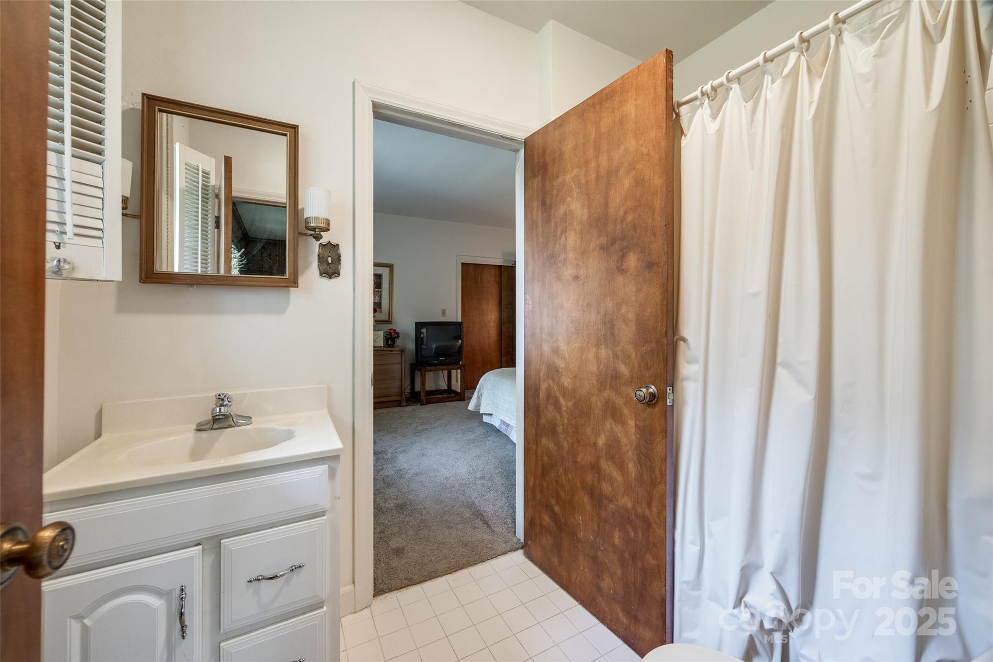 3330 Foxcroft Road Charlotte, NC 28211 - Photo 22 of 39 a bathroom with a sink and mirror