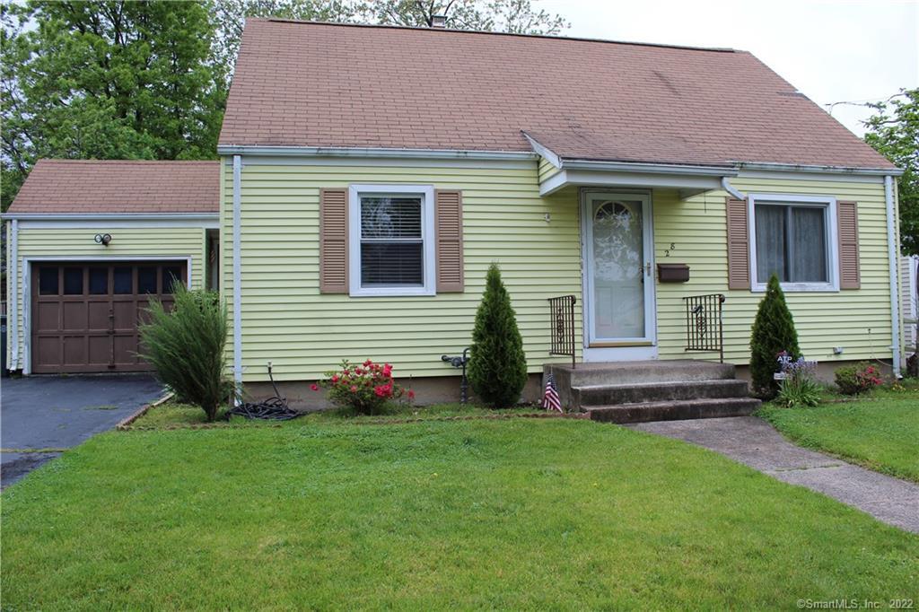 a front view of a house with a yard and fence