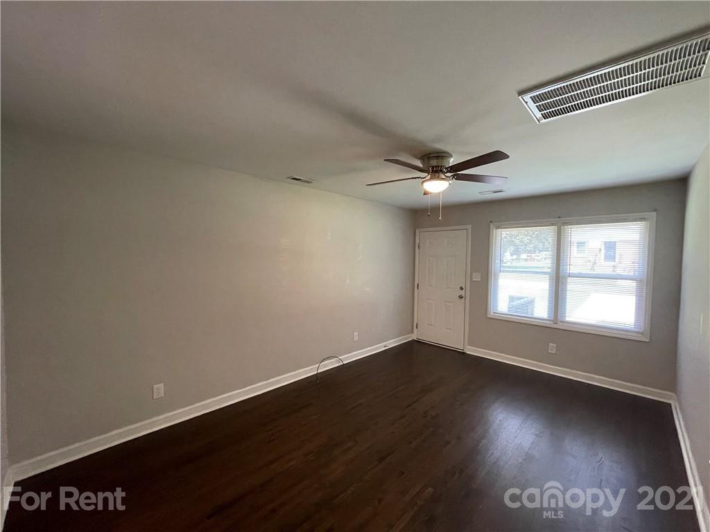 4202 Rutgers Avenue Charlotte, NC 28206 - Photo 2 of 8 an empty room with wooden floor and windows