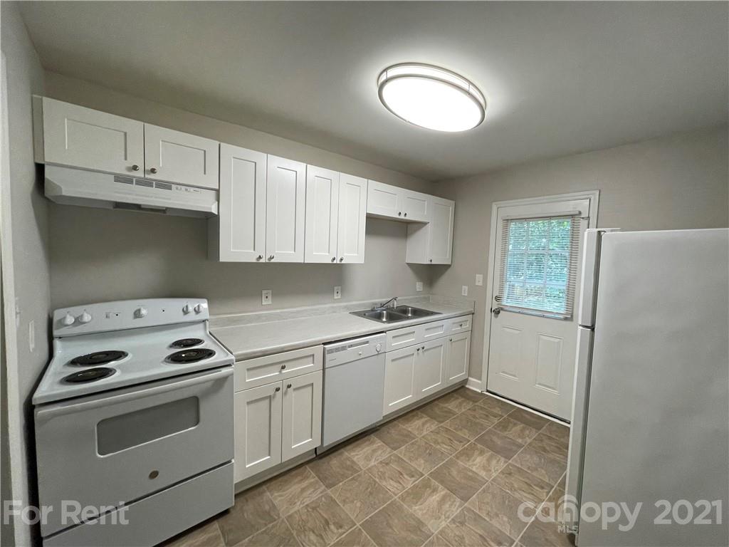4202 Rutgers Avenue Charlotte, NC 28206 - Photo 3 of 8 a kitchen with white cabinets and white appliances