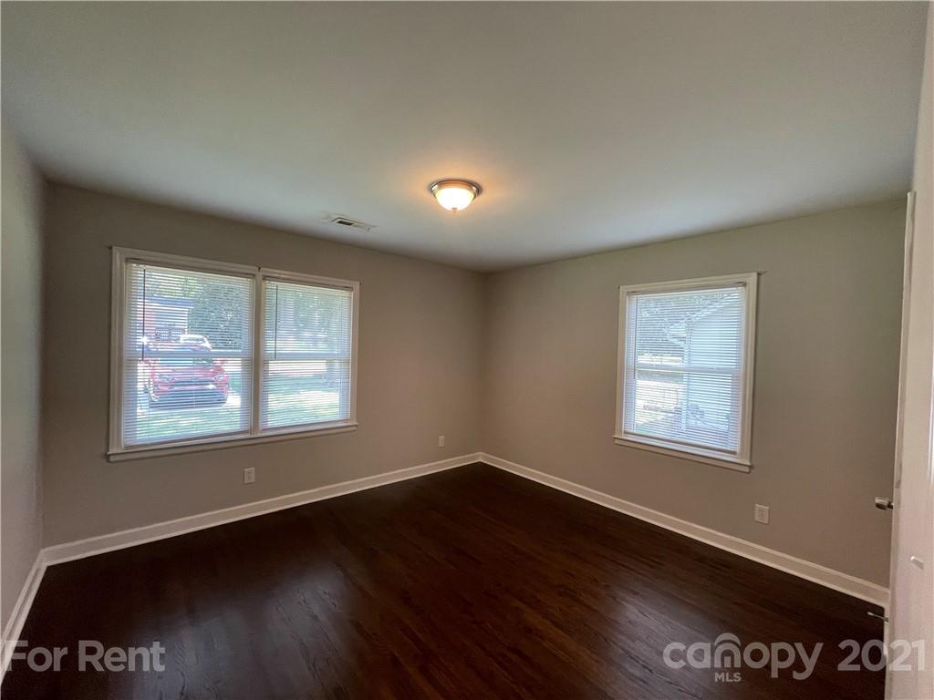4202 Rutgers Avenue Charlotte, NC 28206 - Photo 4 of 8 a view of an empty room with wooden floor and a window