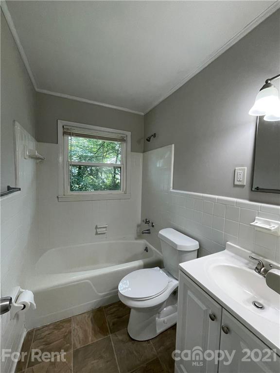 4202 Rutgers Avenue Charlotte, NC 28206 - Photo 5 of 8 a bathroom with a toilet sink a mirror and bathtub