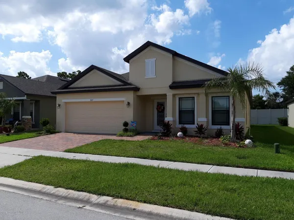 a front view of a house with a yard and porch