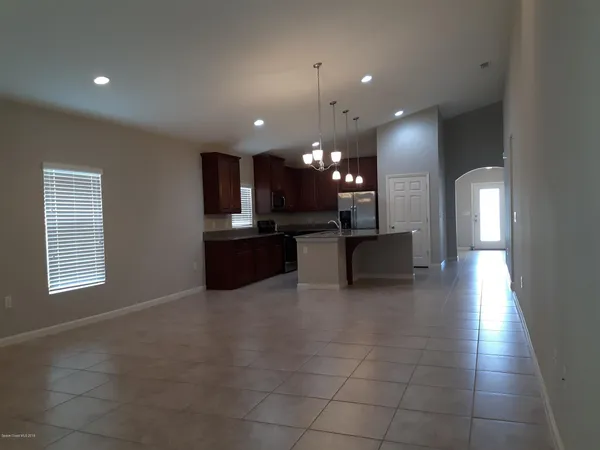 a view of a kitchen with a sink and a fireplace