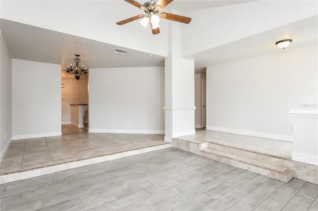 an empty space with wooden floor and entryway