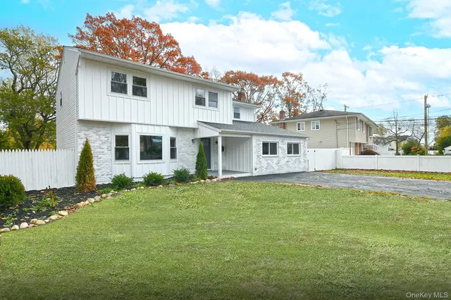 a front view of a house with a garden