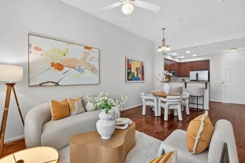 a living room with furniture and a chandelier