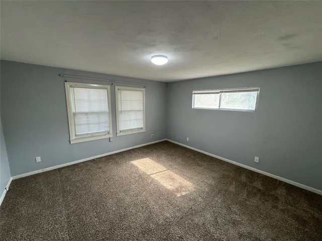 an empty room with a empty space and windows