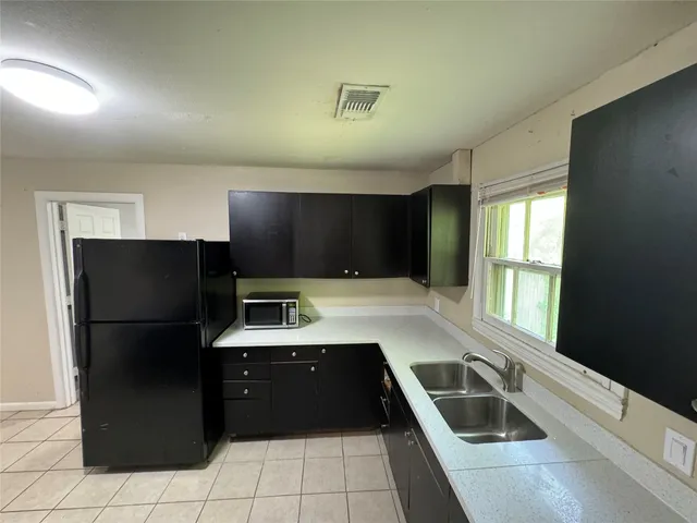 a kitchen with a refrigerator and a sink