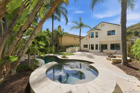 a swimming pool with outdoor seating and yard