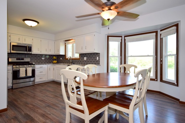 S950 Spring Green Way Batavia, IL 60510 - Photo 5 of 25 a view of a dining room with furniture window and wooden floor