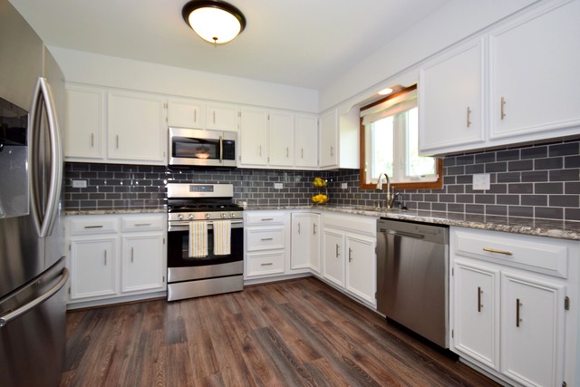 S950 Spring Green Way Batavia, IL 60510 - Photo 8 of 25 a kitchen with granite countertop white cabinets and white appliances
