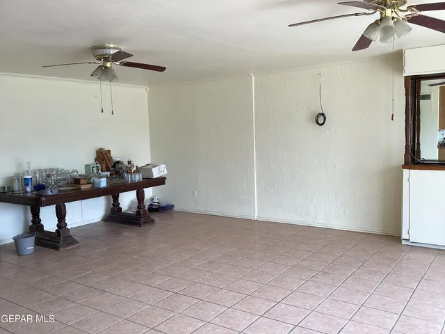 a view of a livingroom with furniture and a ceiling fan