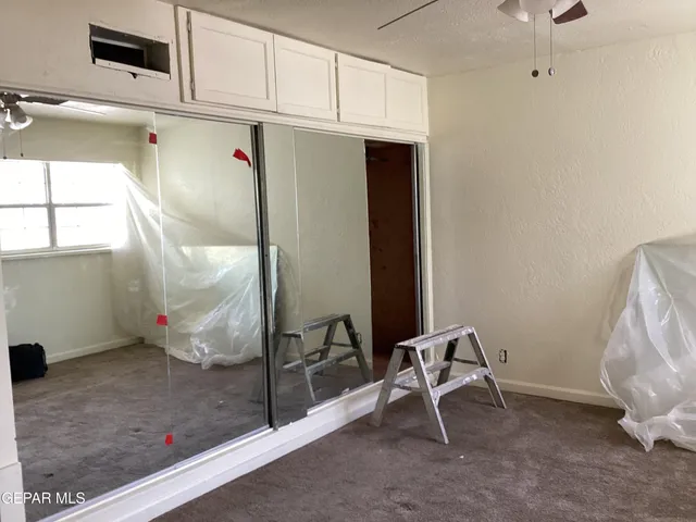 a view of a room with wooden floor and windows